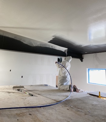 Photo of Logan painter spraying ceiling
